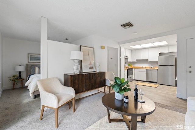 living room featuring light hardwood / wood-style floors and sink