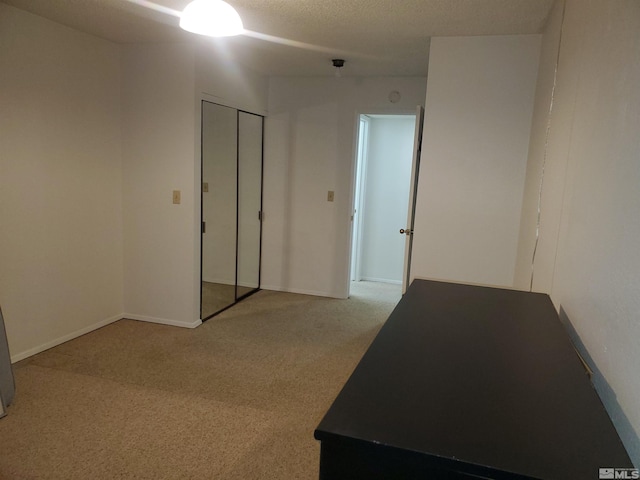 carpeted empty room featuring a textured ceiling