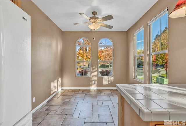 doorway to outside with ceiling fan