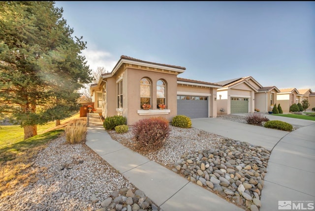 mediterranean / spanish home with a garage