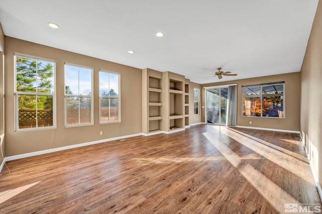 unfurnished living room with ceiling fan and hardwood / wood-style flooring