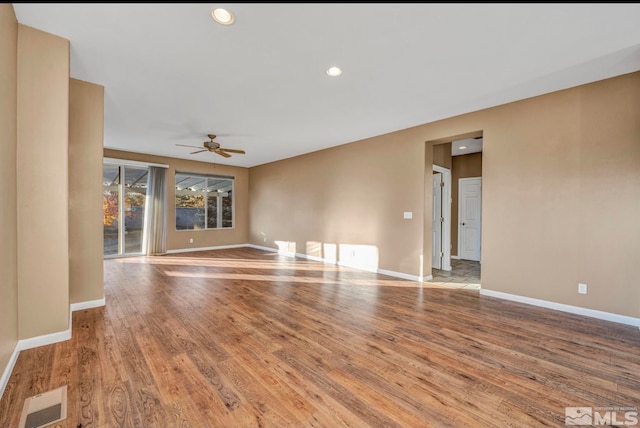 spare room with ceiling fan and light wood-type flooring