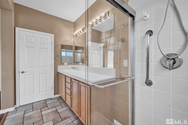 bathroom featuring tile patterned flooring, vanity, and an enclosed shower