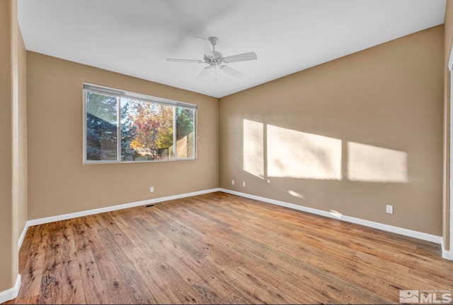 spare room featuring ceiling fan and light hardwood / wood-style flooring