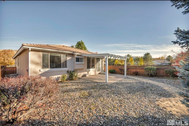 back of property featuring a pergola and a patio