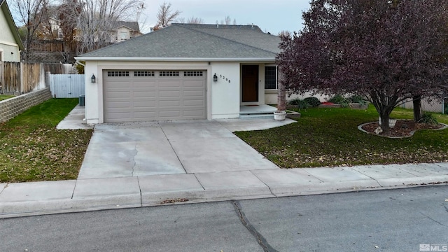 view of front facade with a garage and a front lawn