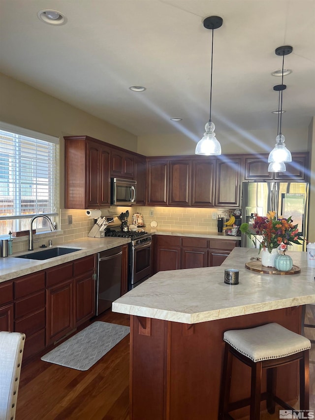 kitchen with tasteful backsplash, sink, stainless steel appliances, and dark hardwood / wood-style floors