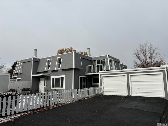 view of front of home featuring a garage and a balcony