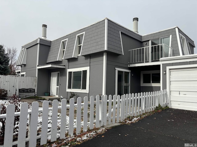 view of front facade with a balcony and a garage