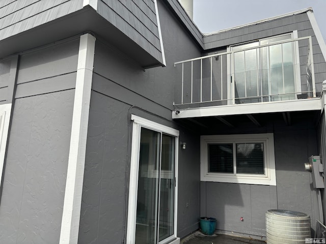 view of home's exterior with a balcony and central air condition unit