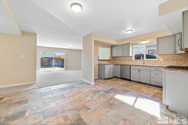 kitchen with gray cabinetry, decorative backsplash, a healthy amount of sunlight, and appliances with stainless steel finishes