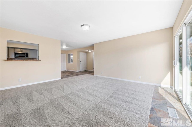 carpeted spare room with a healthy amount of sunlight