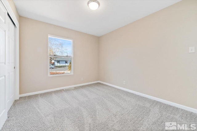 unfurnished bedroom featuring carpet and a closet