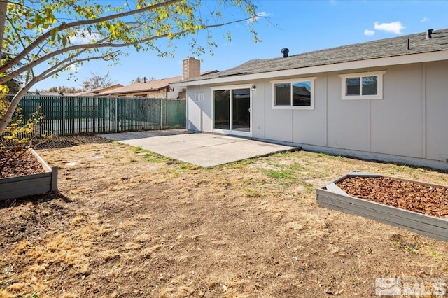 back of property with a patio