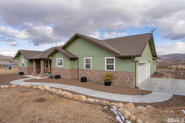 craftsman house with a mountain view and a garage