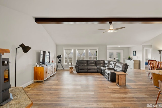 living room with ceiling fan, hardwood / wood-style floors, lofted ceiling with beams, and french doors