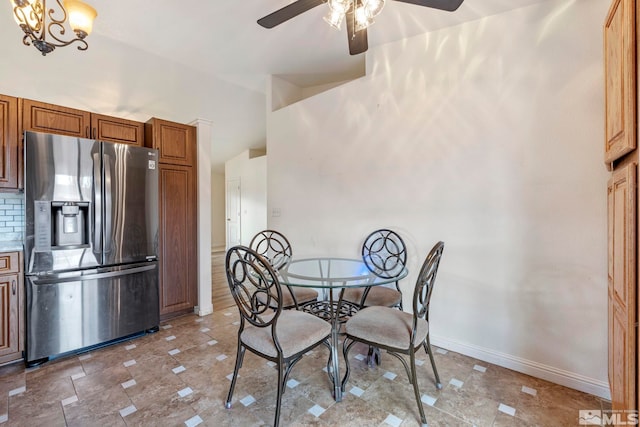 dining area with lofted ceiling and ceiling fan with notable chandelier