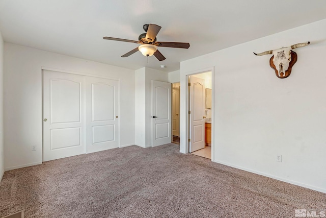 unfurnished bedroom with ceiling fan, light colored carpet, connected bathroom, and a closet