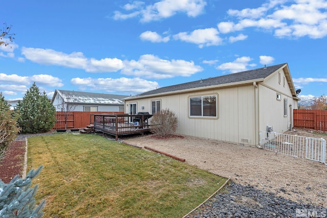 rear view of property with a lawn and a deck