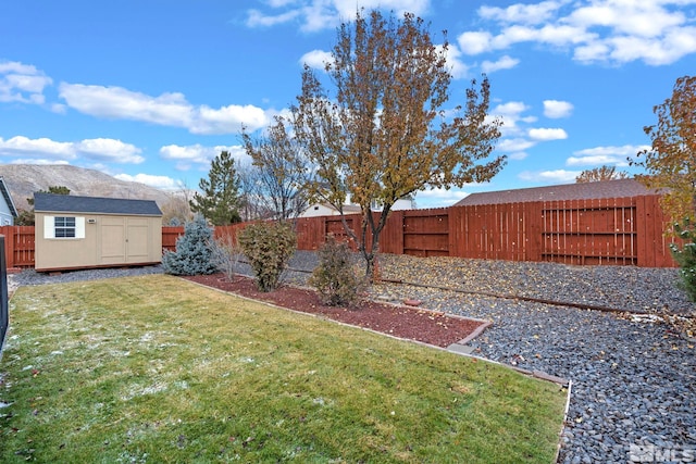 view of yard featuring a storage unit and a mountain view