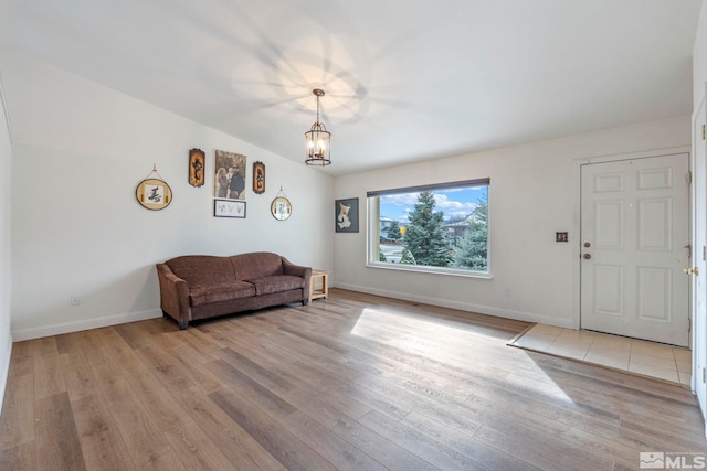 living room featuring light hardwood / wood-style flooring and a notable chandelier