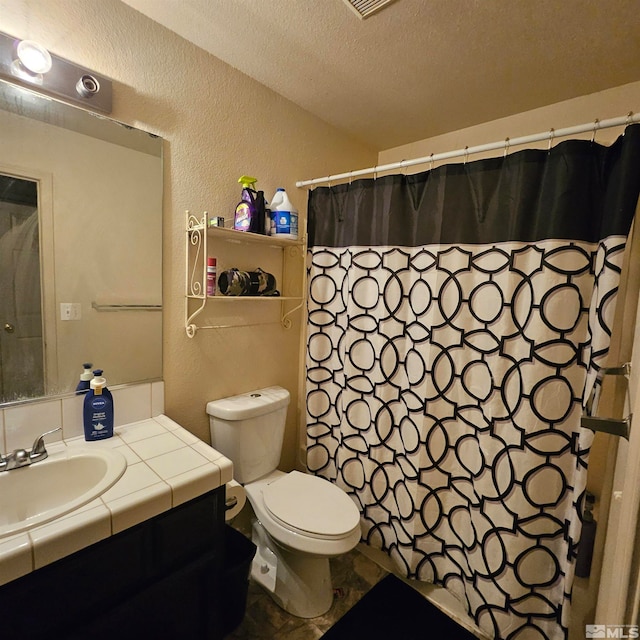 bathroom with vanity, a shower with curtain, a textured ceiling, and toilet