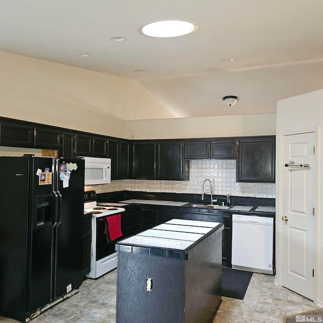 kitchen with decorative backsplash, sink, a kitchen island, and white appliances