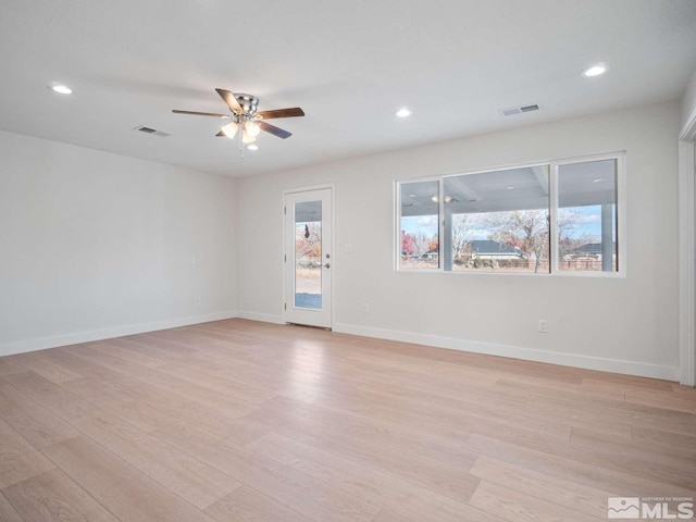 empty room featuring light hardwood / wood-style flooring and ceiling fan