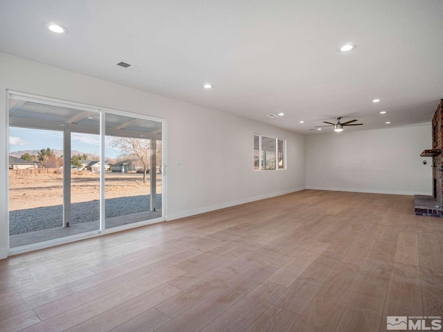 unfurnished living room featuring light hardwood / wood-style floors and ceiling fan