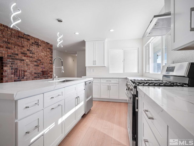 kitchen featuring stainless steel appliances, white cabinetry, hanging light fixtures, and exhaust hood