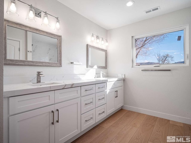 bathroom featuring vanity and wood-type flooring