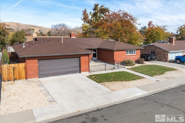 single story home featuring a mountain view and a garage