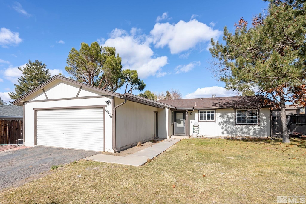 single story home with a garage and a front lawn