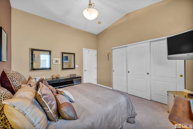 bedroom featuring a closet, light carpet, and vaulted ceiling