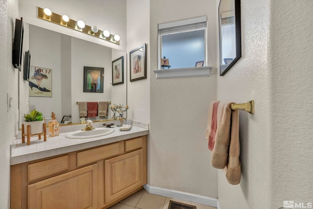 bathroom featuring tile patterned flooring and vanity