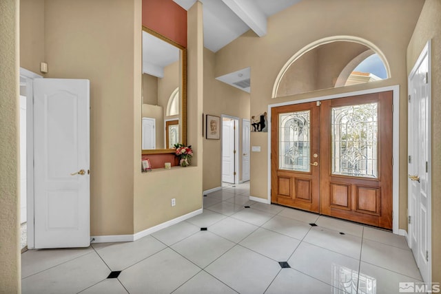 entryway with french doors, high vaulted ceiling, beamed ceiling, and light tile patterned floors