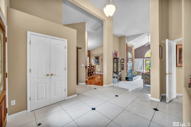 tiled foyer entrance with ceiling fan