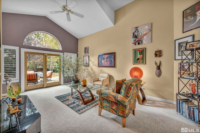 carpeted living room with high vaulted ceiling and ceiling fan