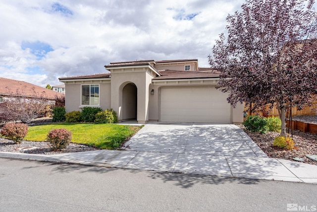 mediterranean / spanish-style home with a garage and a front lawn