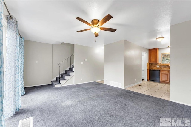 unfurnished living room featuring light colored carpet and ceiling fan