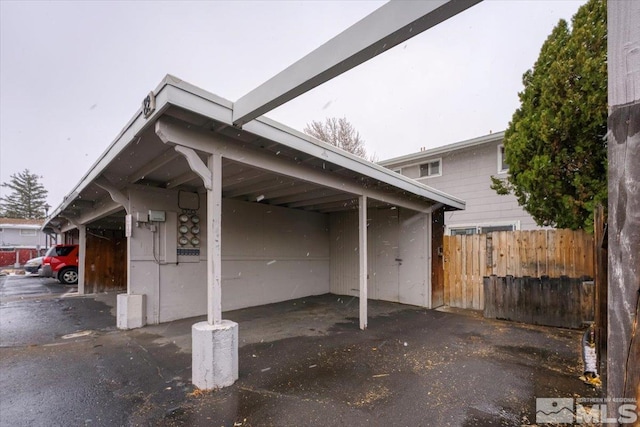 view of parking / parking lot featuring a carport