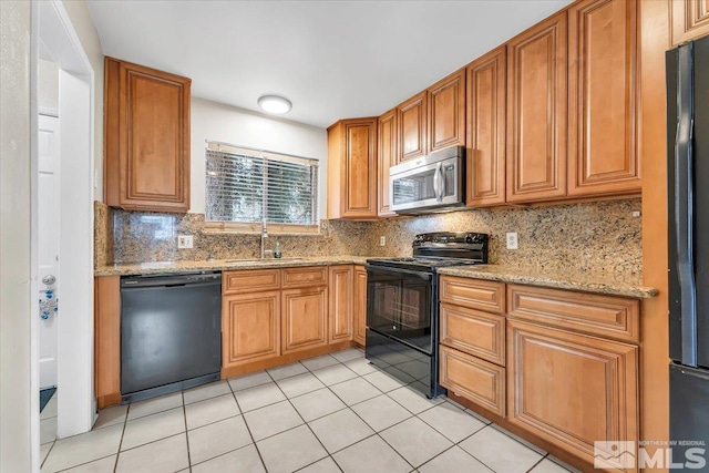 kitchen with light tile patterned floors, sink, tasteful backsplash, and black appliances