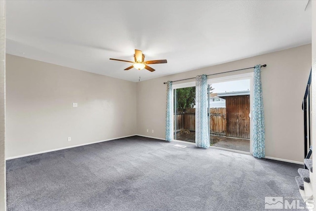 carpeted empty room featuring ceiling fan