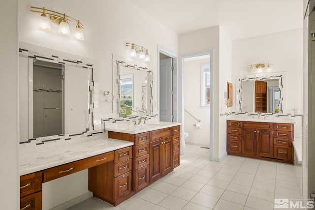 bathroom with vanity, tasteful backsplash, and tile patterned floors