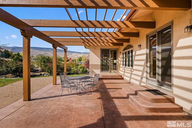 view of patio / terrace featuring a pergola and a mountain view