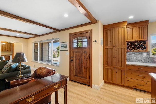 entryway with beam ceiling and light hardwood / wood-style floors