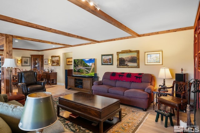 living room featuring beamed ceiling and light hardwood / wood-style floors