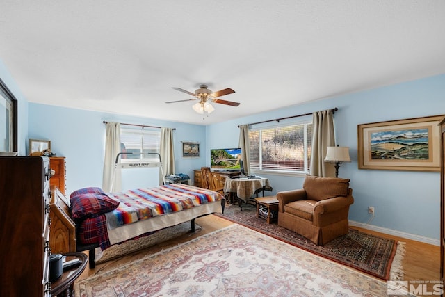 bedroom with ceiling fan and hardwood / wood-style floors