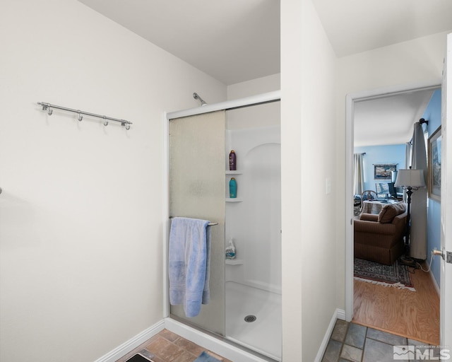 bathroom featuring hardwood / wood-style floors and a shower with shower door