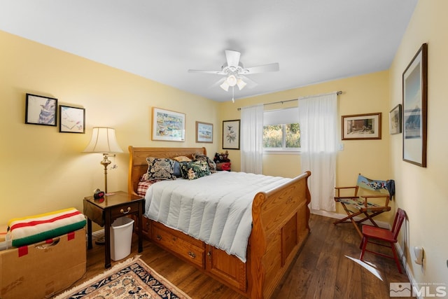 bedroom with ceiling fan and dark wood-type flooring